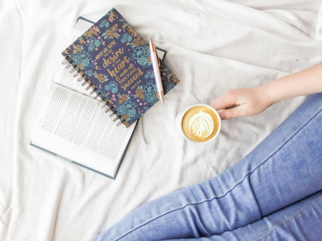 Woman relaxing with coffee and a journal — the Sunday reset habit checkpoint